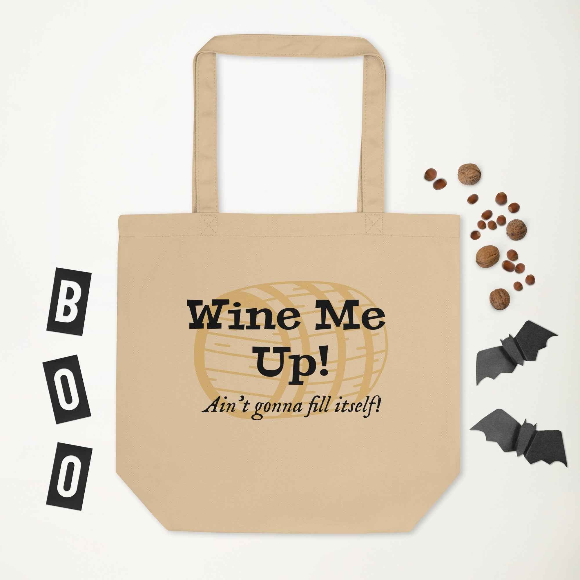 Tote bag design featuring the phrase “Wine Me Up! Ain’t gonna fill itself!” over a wine barrel illustration. A playful nod to wine enthusiasm and cheeky humor.