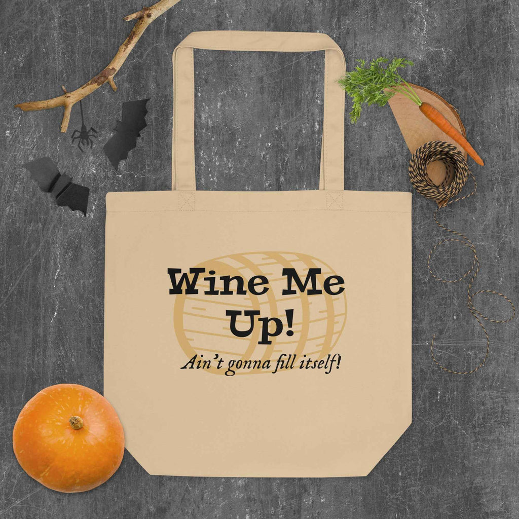 Tote bag featuring the phrase “Wine Me Up! Ain’t gonna fill itself!” over a wine barrel illustration. A playful nod to wine enthusiasm and cheeky humor.