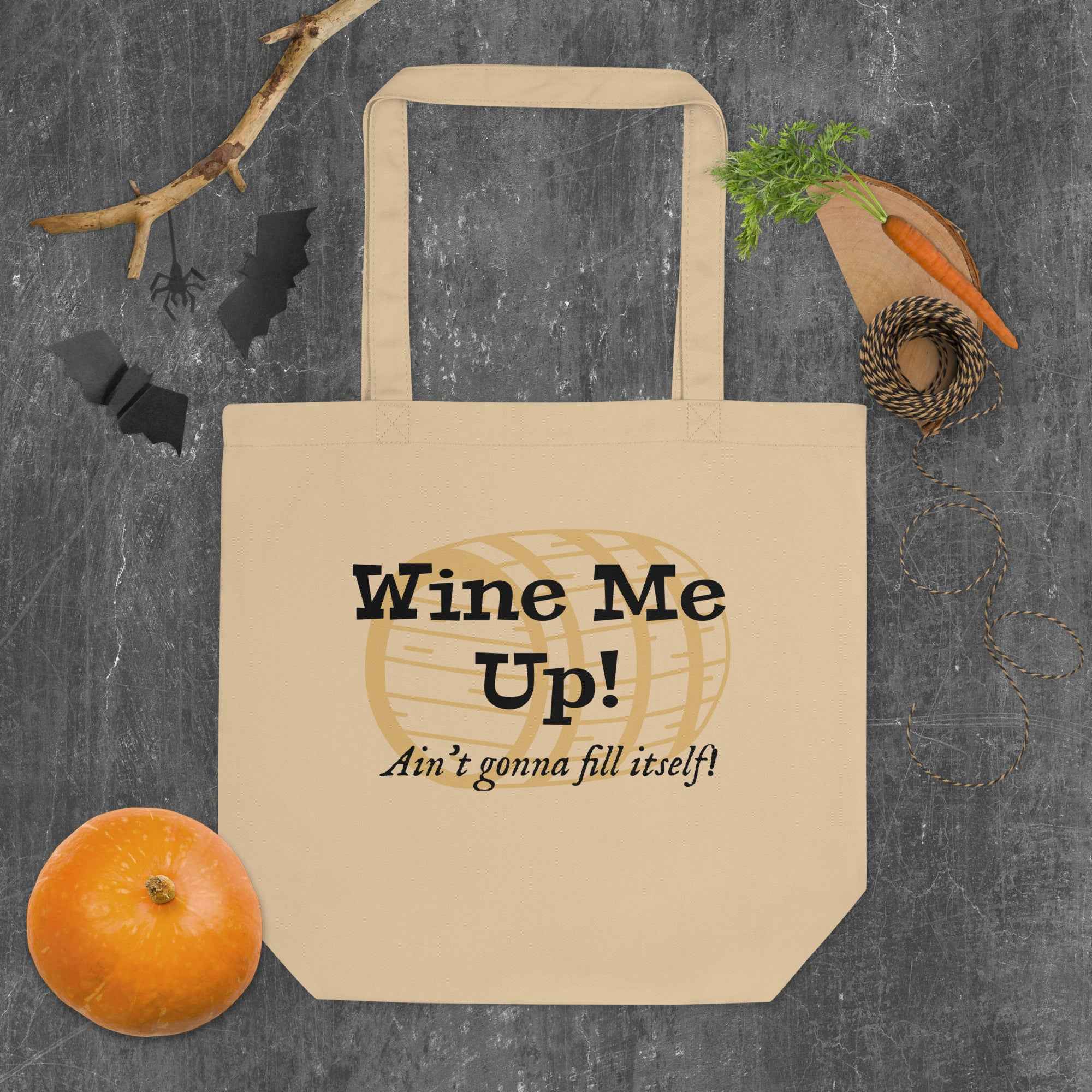 Tote bag featuring the phrase “Wine Me Up! Ain’t gonna fill itself!” over a wine barrel illustration. A playful nod to wine enthusiasm and cheeky humor.