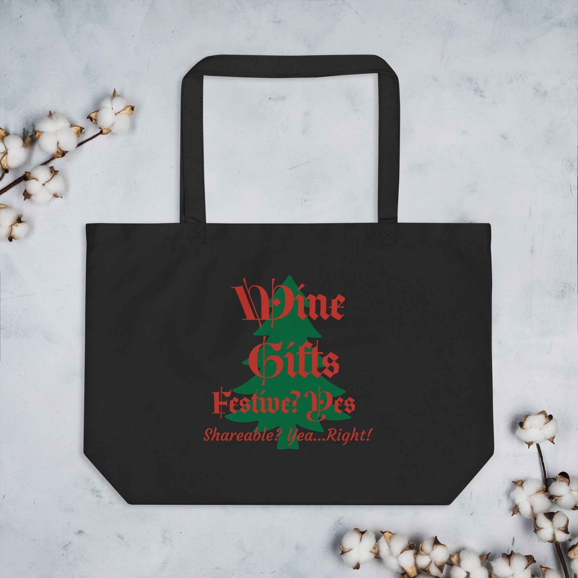 Black tote bag with red and green text shaped like a Christmas tree. Reads: “Wine Gifts—Festive? Yes. Shareable? Yea…Right!” Features a wine glass forming the “W” and a green tree silhouette. A humorous holiday gift for wine lovers.