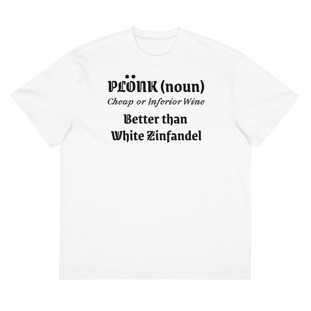 White cotton t-shirt laid flat with bold black text reading “Plonk; noun. Cheap wine, better than White Zinfandel.” Surrounded by retro wine props and blush-toned accents.