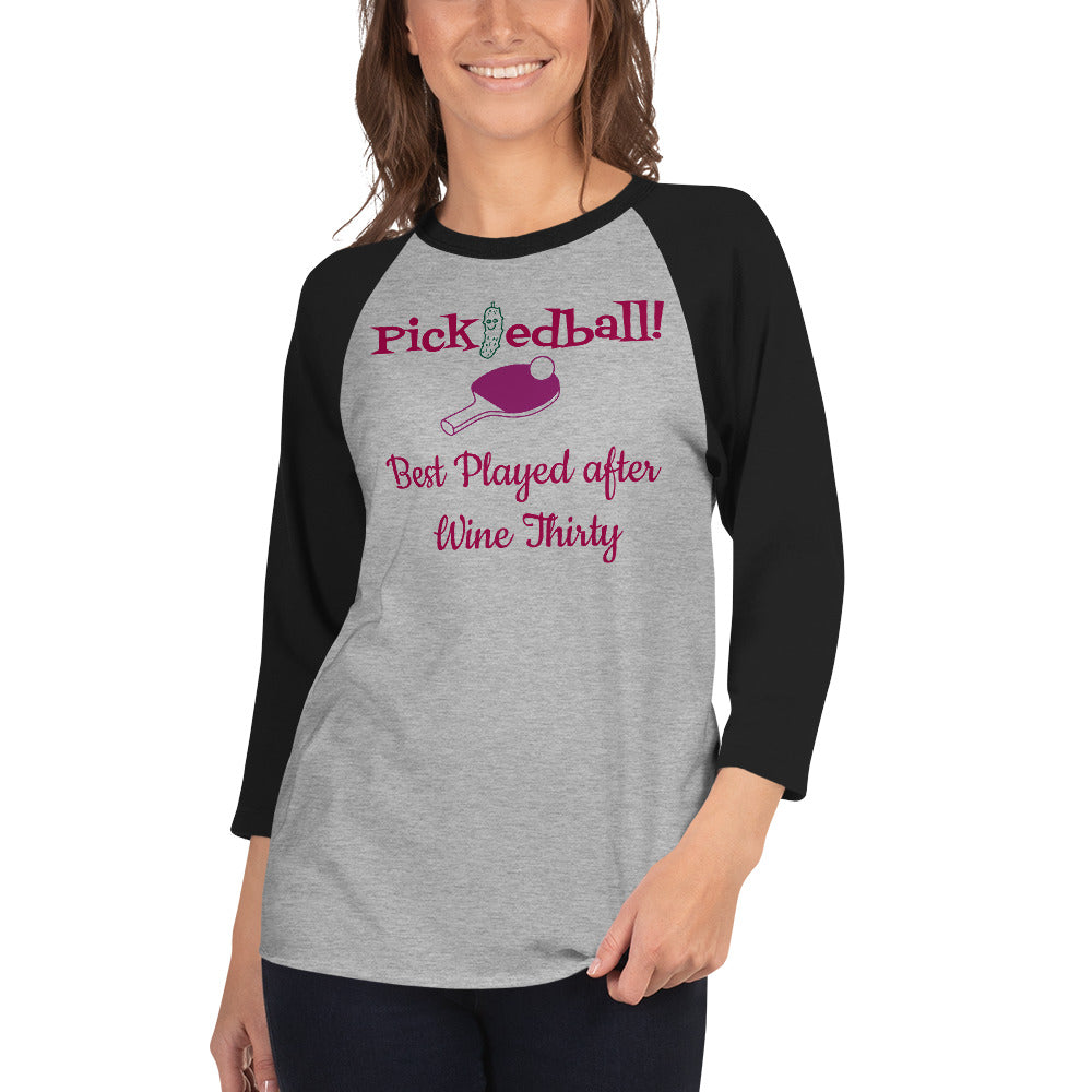 Black/gray Women’s raglan-style shirt with wine-themed pickleball slogan ‘Pickledball! Best Played after Wine Thirty’—features pink paddle and ball graphic, lightweight fit, perfect for tipsy matches and spirited rallies.”
