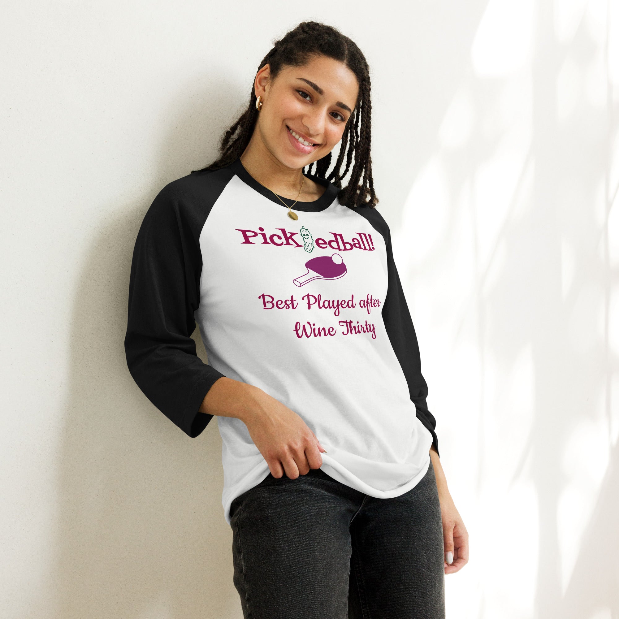 Black/white Women’s raglan-style shirt with wine-themed pickleball slogan ‘Pickledball! Best Played after Wine Thirty’—features pink paddle and ball graphic, lightweight fit, perfect for tipsy matches and spirited rallies.”