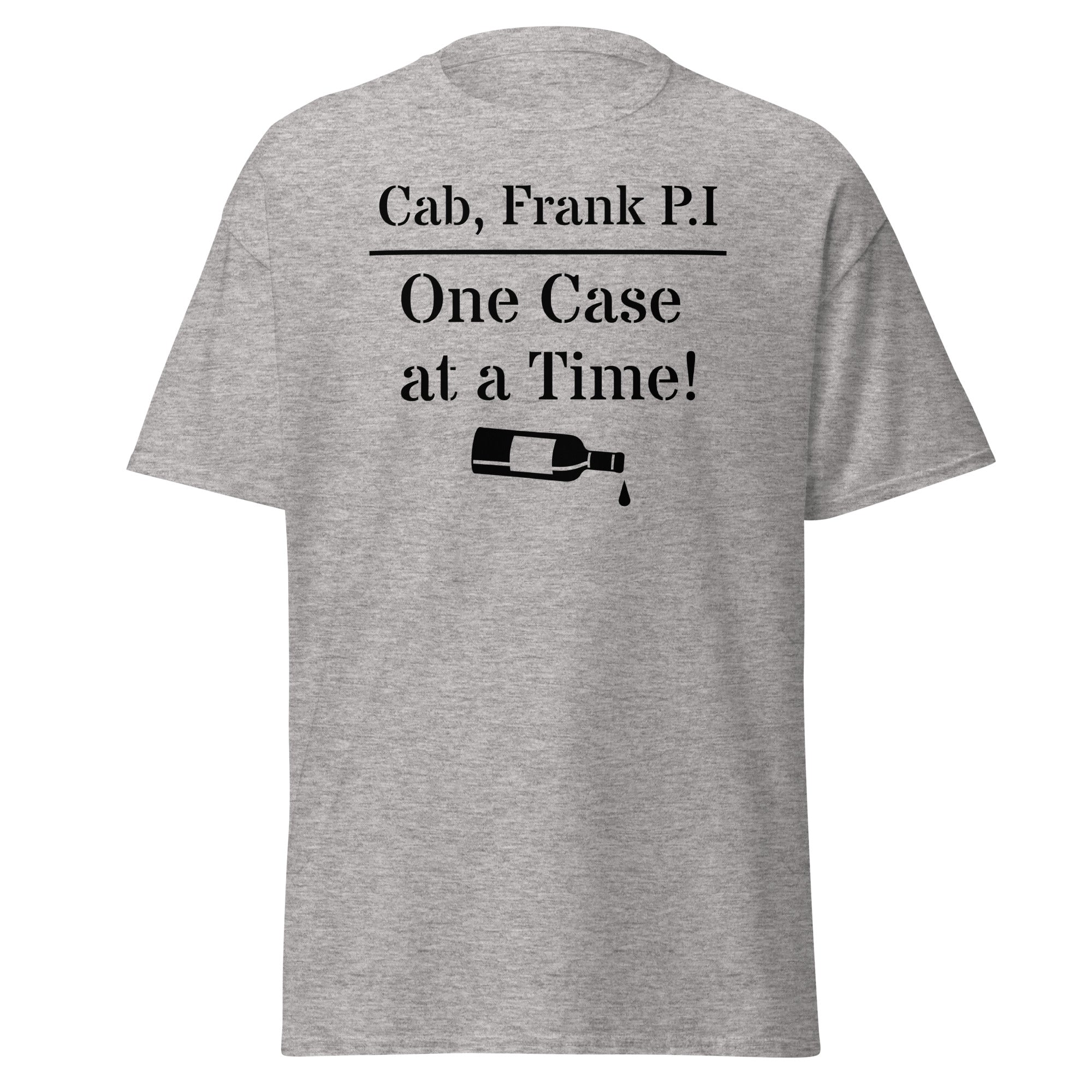 Gray cotton t-shirt with bold black text reading “Cab, Frank. P.I. – One Case at a Time,” styled with vintage wine bottles, corks, and noir props like sunglasses and a magnifying glass to evoke detective satire and vineyard mystery.