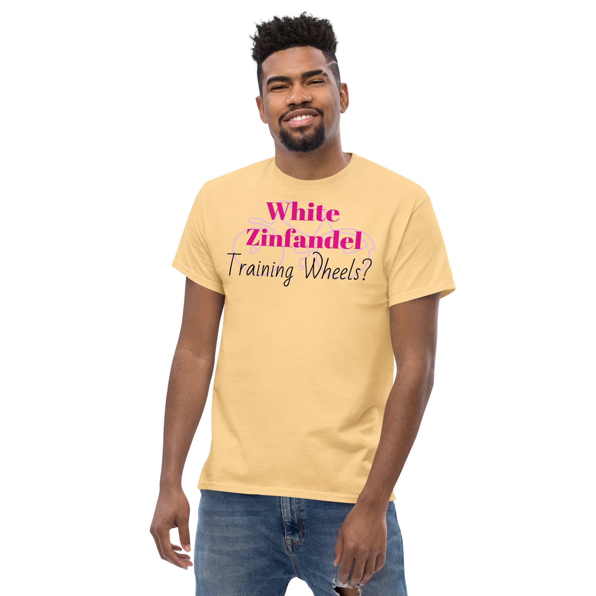 Yellow White Zinfandel – Training Wheels tee laid flat on a rustic wood surface, featuring bold satirical text in vintage script. A soft blush-pink cotton shirt that hints at wine-fueled nostalgia and emotional rites of passage.