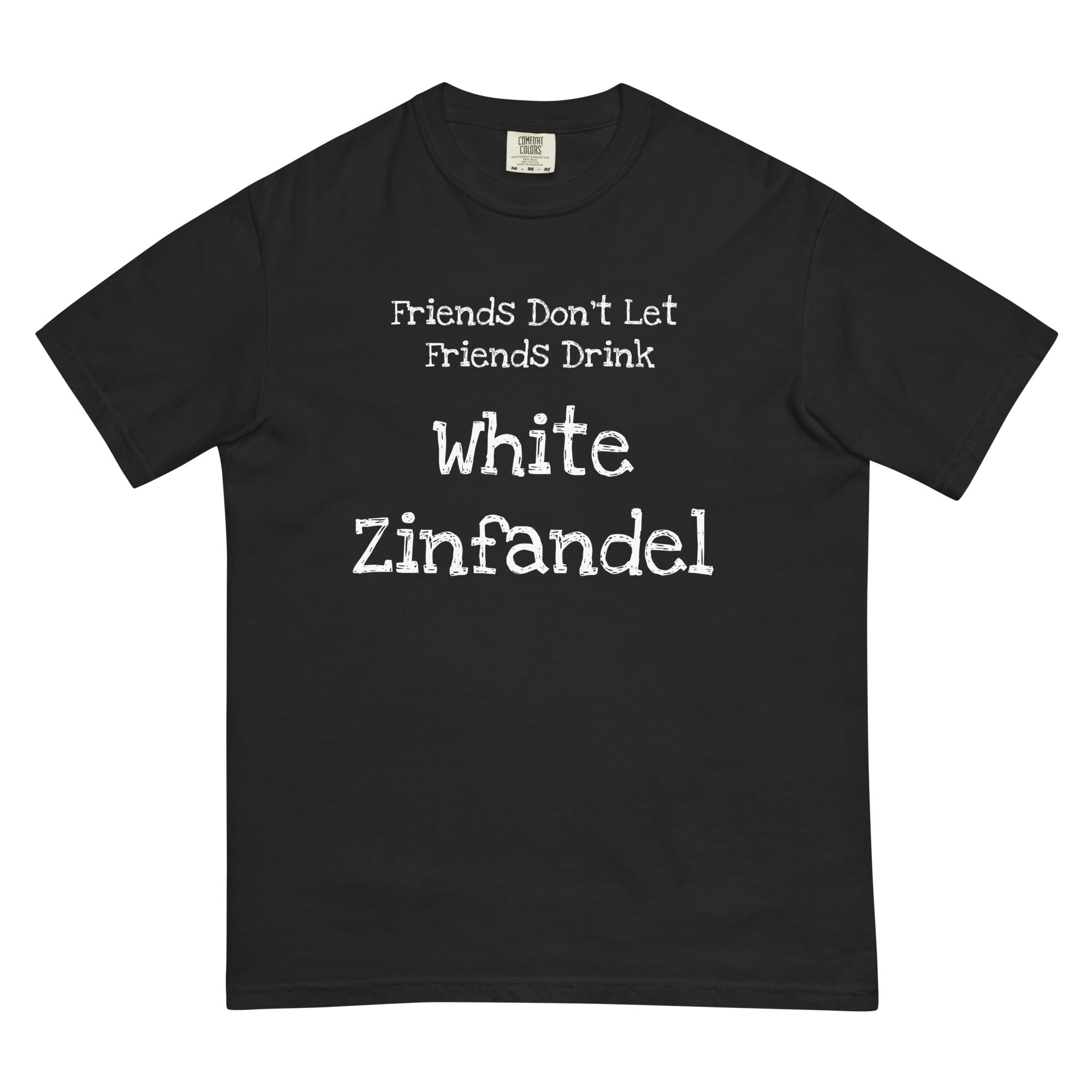 White cotton t-shirt laid flat with bold black text reading “Friends Don’t Let Friends Drink White Zinfandel.” Styled with retro wine props and blush-toned accents for a satirical, nostalgic vibe.