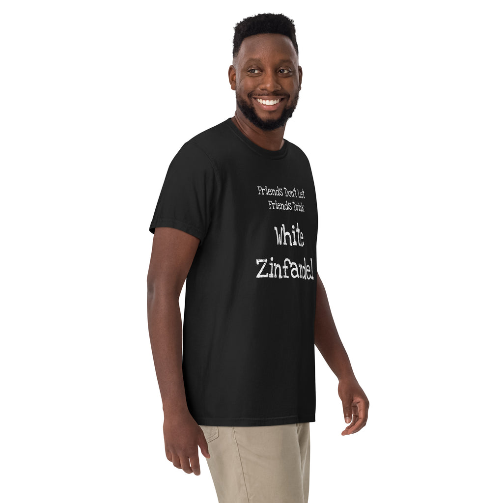 White cotton t-shirt laid flat with bold black text reading “Friends Don’t Let Friends Drink White Zinfandel.” Styled with retro wine props and blush-toned accents for a satirical, nostalgic vibe.
