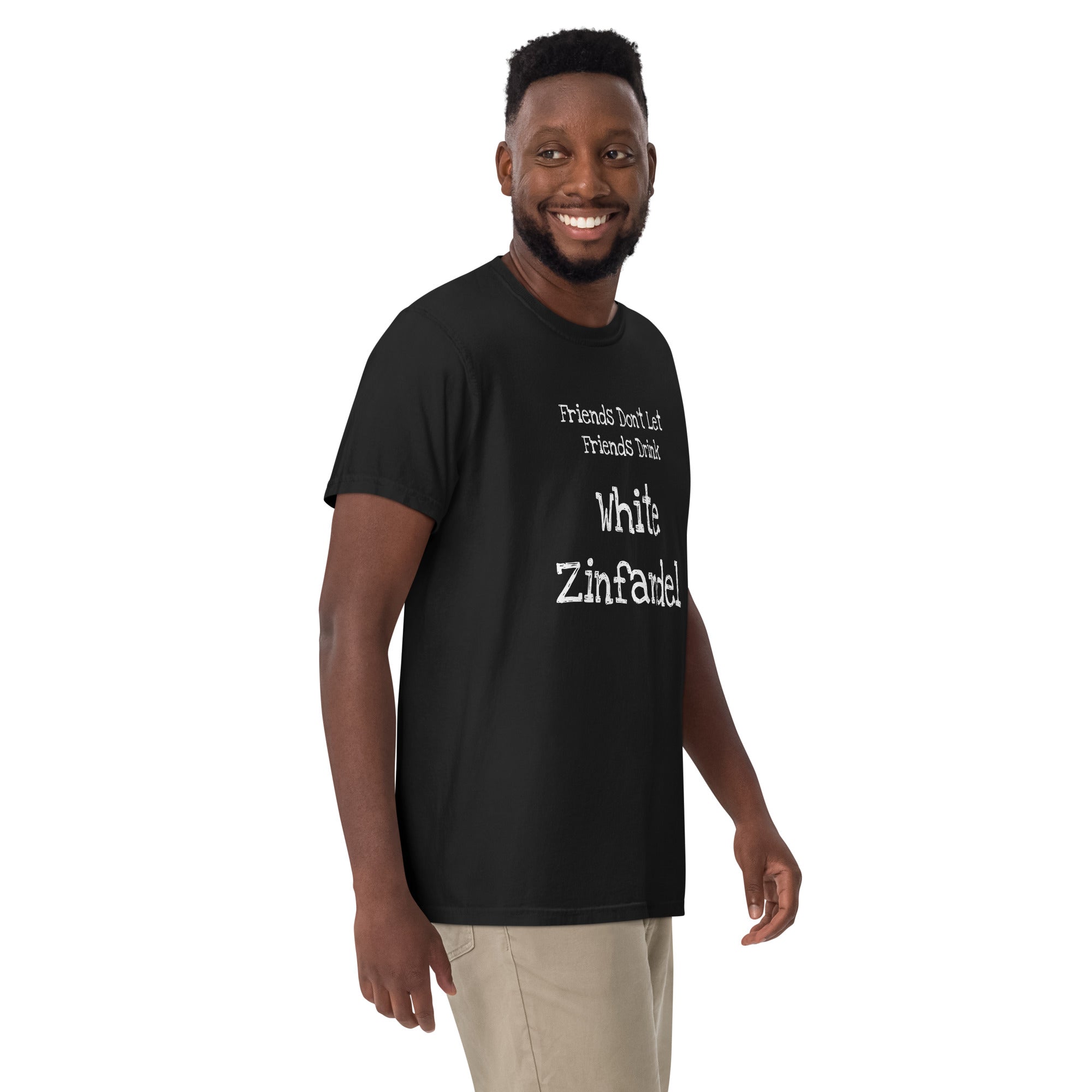 White cotton t-shirt laid flat with bold black text reading “Friends Don’t Let Friends Drink White Zinfandel.” Styled with retro wine props and blush-toned accents for a satirical, nostalgic vibe.