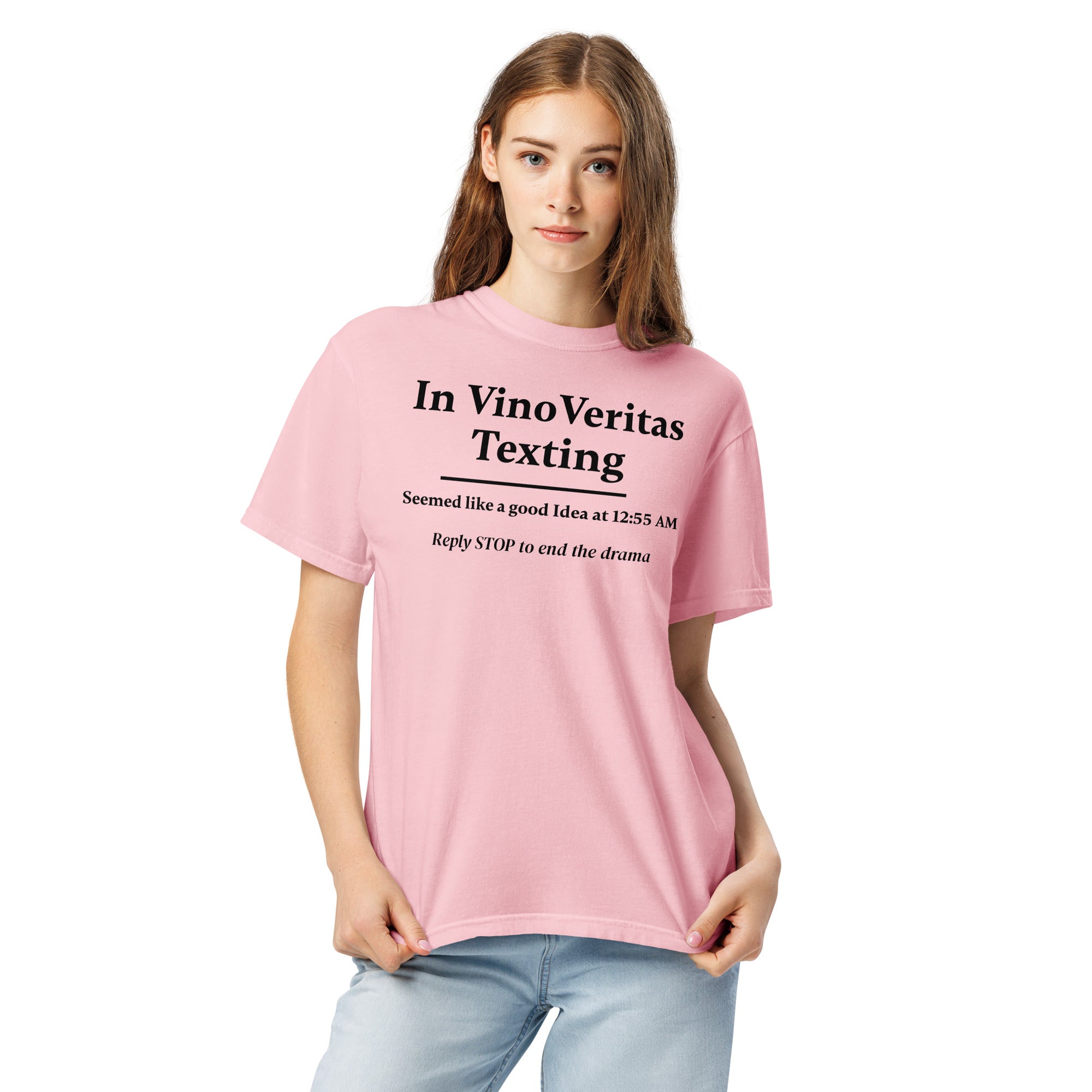 Pink T-shirt with bold black text that reads: “In Vino Veritas Texting — Seemed like a good idea at 12:55 AM. Reply STOP to end the drama.” A humorous nod to wine-fueled late-night texting and automated message culture.