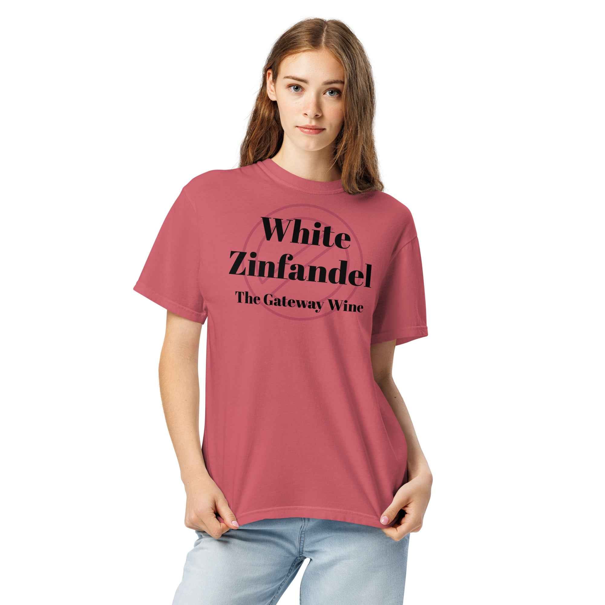 Mauve cotton t-shirt displayed flat with bold text reading “White Zinfandel: The Gateway Wine.” Styled with blush-toned props, retro wine glass, and soft lighting for a nostalgic vibe.