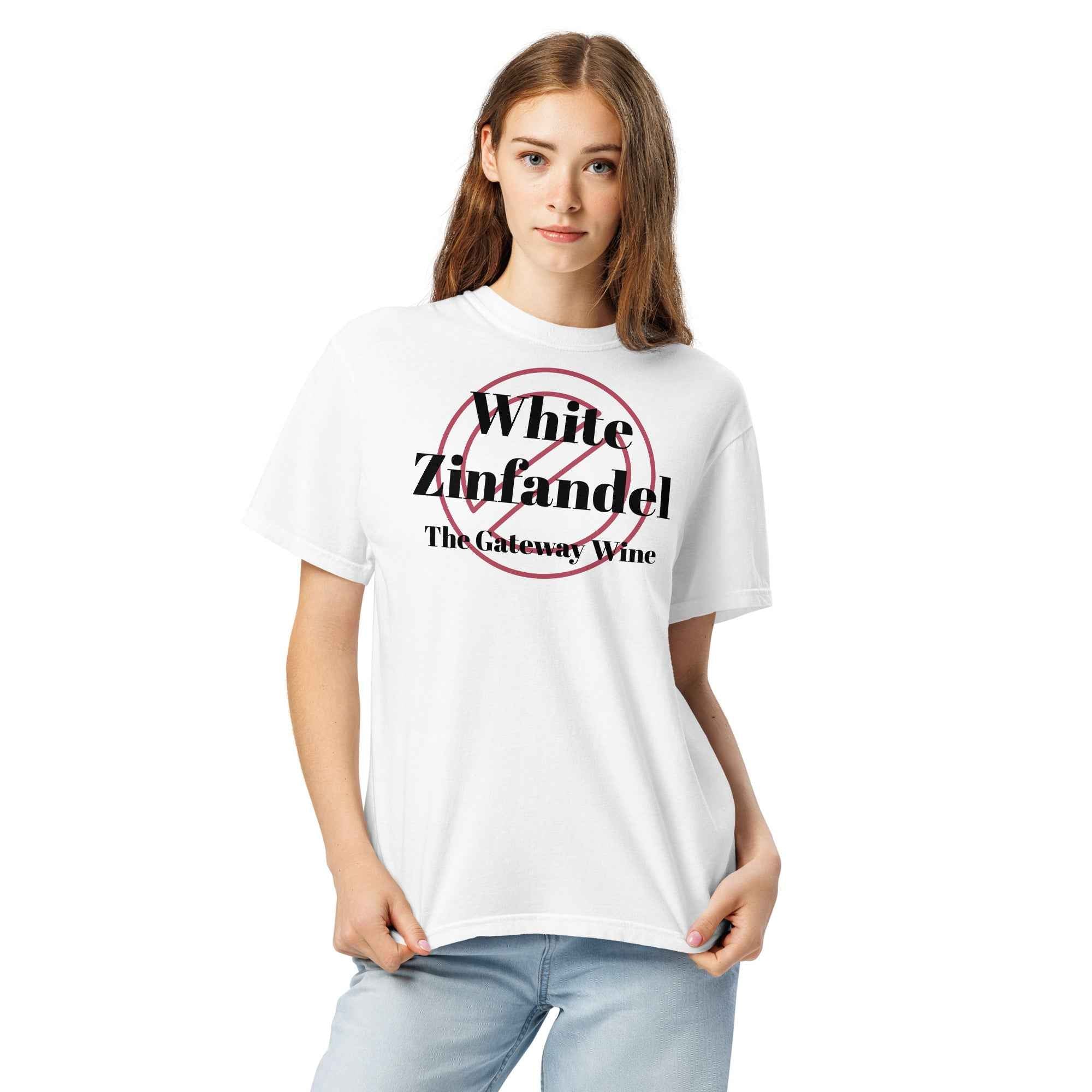 White cotton t-shirt displayed flat with bold text reading “White Zinfandel: The Gateway Wine.” Styled with blush-toned props, retro wine glass, and soft lighting for a nostalgic vibe.