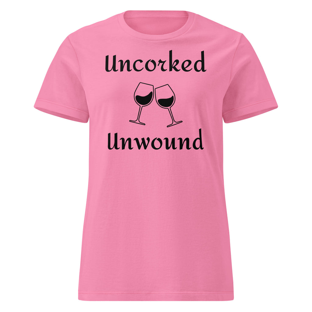 Pink Cotton t-shirt laid flat with elegant script reading “Uncorked and Unwound.” Styled with a corkscrew, wine glass, and soft blush-toned props to evoke relaxation and ritual.