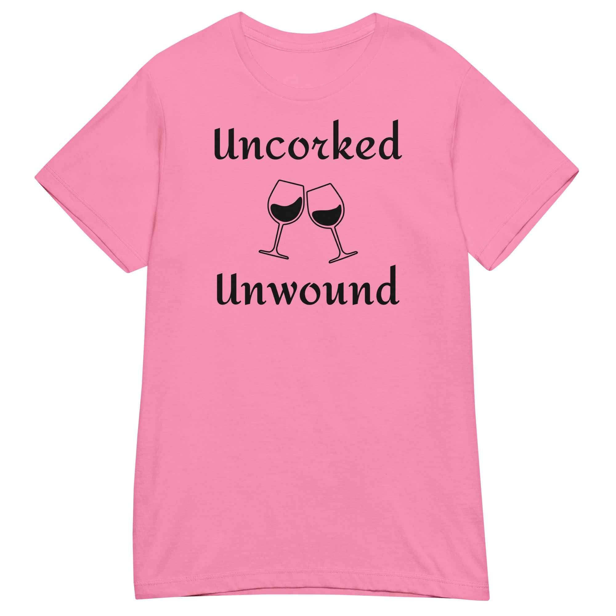  Cotton t-shirt laid flat with elegant script reading “Uncorked and Unwound.” Styled with a corkscrew, wine glass, and soft blush-toned props to evoke relaxation and ritual.