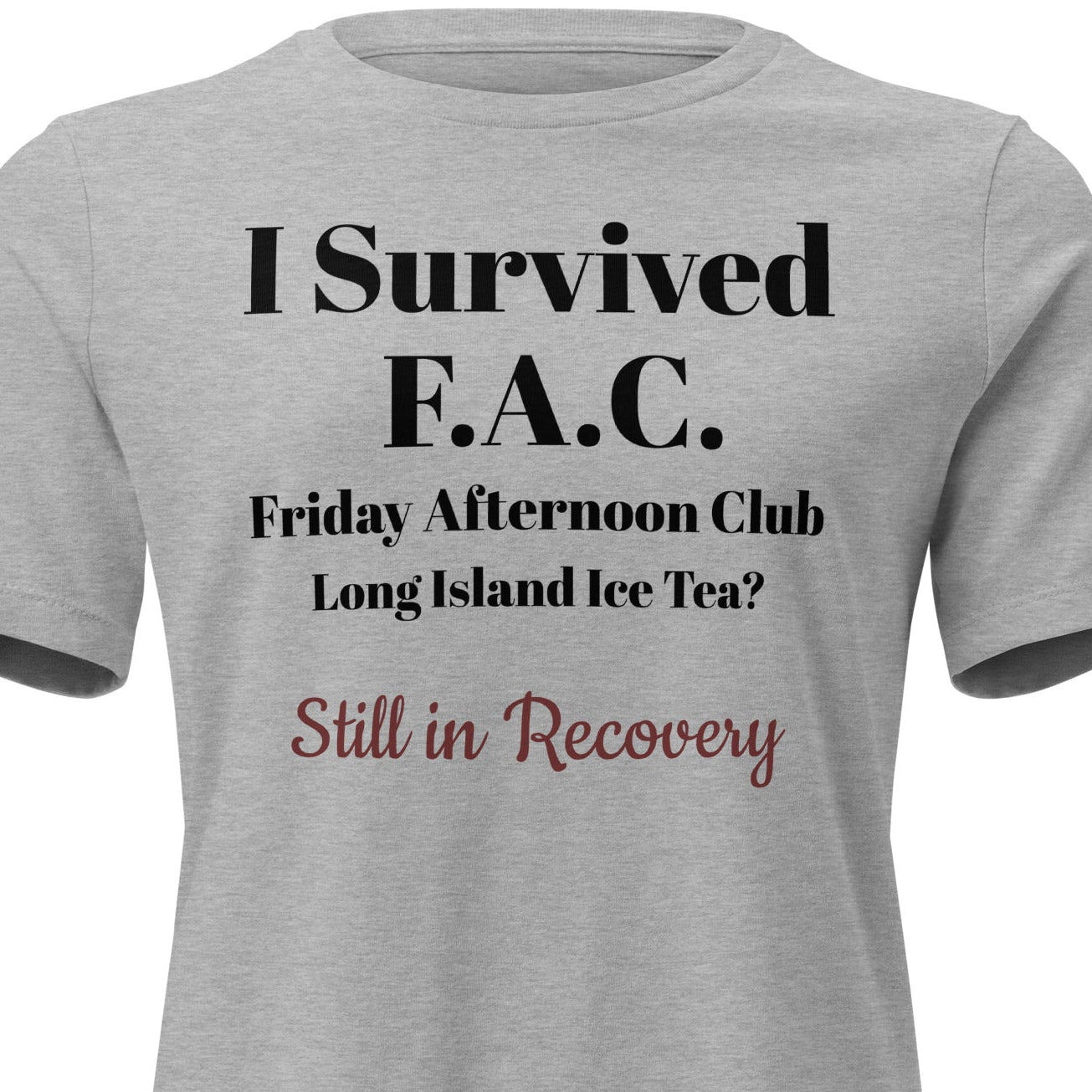 Grey cotton t-shirt laid flat with bold black text reading “I Survived Friday Afternoon Club – Still in Recovery.” Surrounded by wine corks, sunglasses, and a half-empty bottle, evoking post-party resilience and weekend rituals.